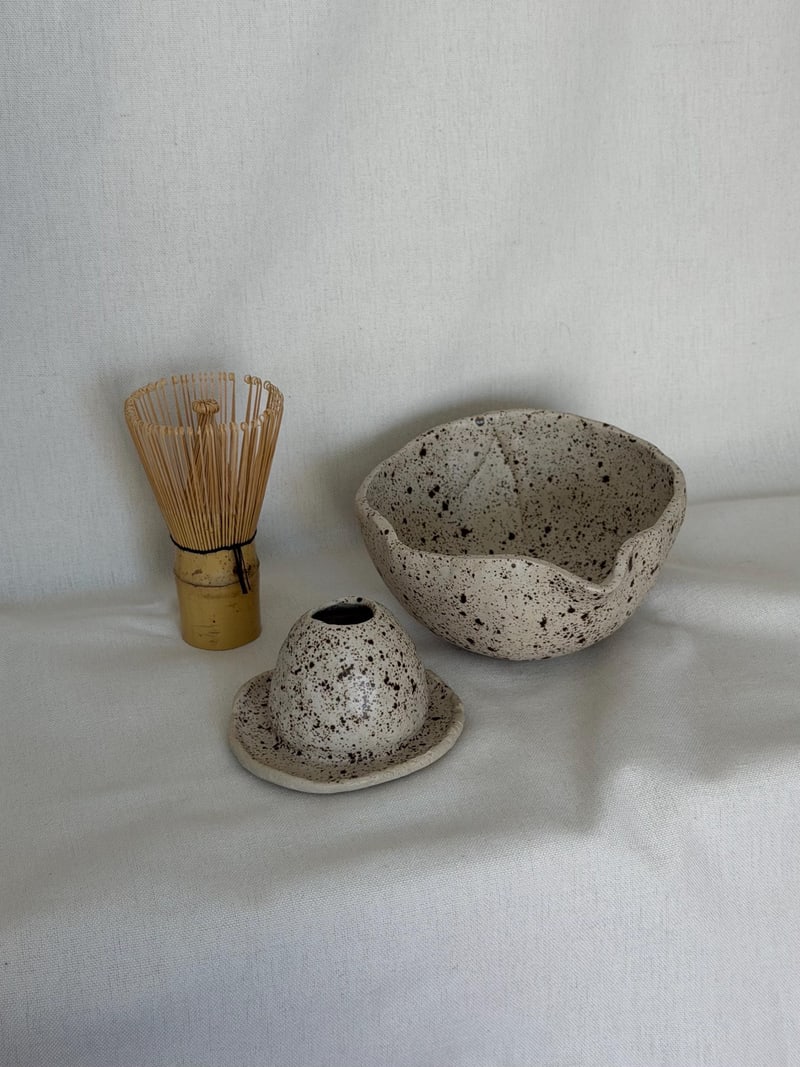 Matcha set II, a handbuilt speckled ceramic bowl with a bamboo whisk and a whisk rest