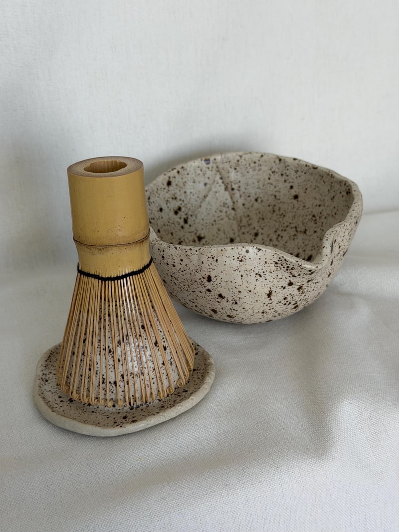 Matcha set II, a handbuilt speckled ceramic bowl with a bamboo whisk and a whisk rest